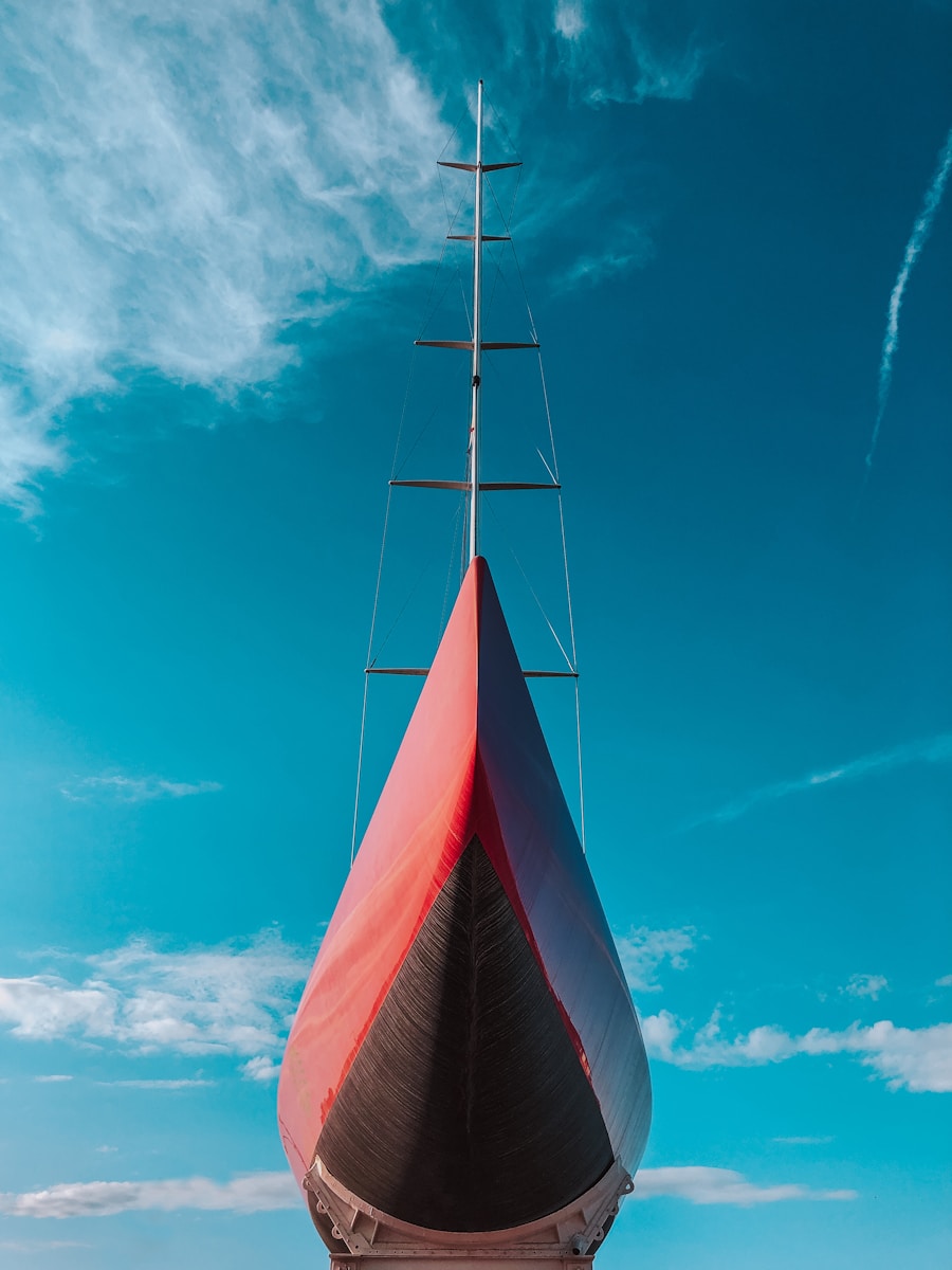 white and red wind turbine under blue sky during daytime